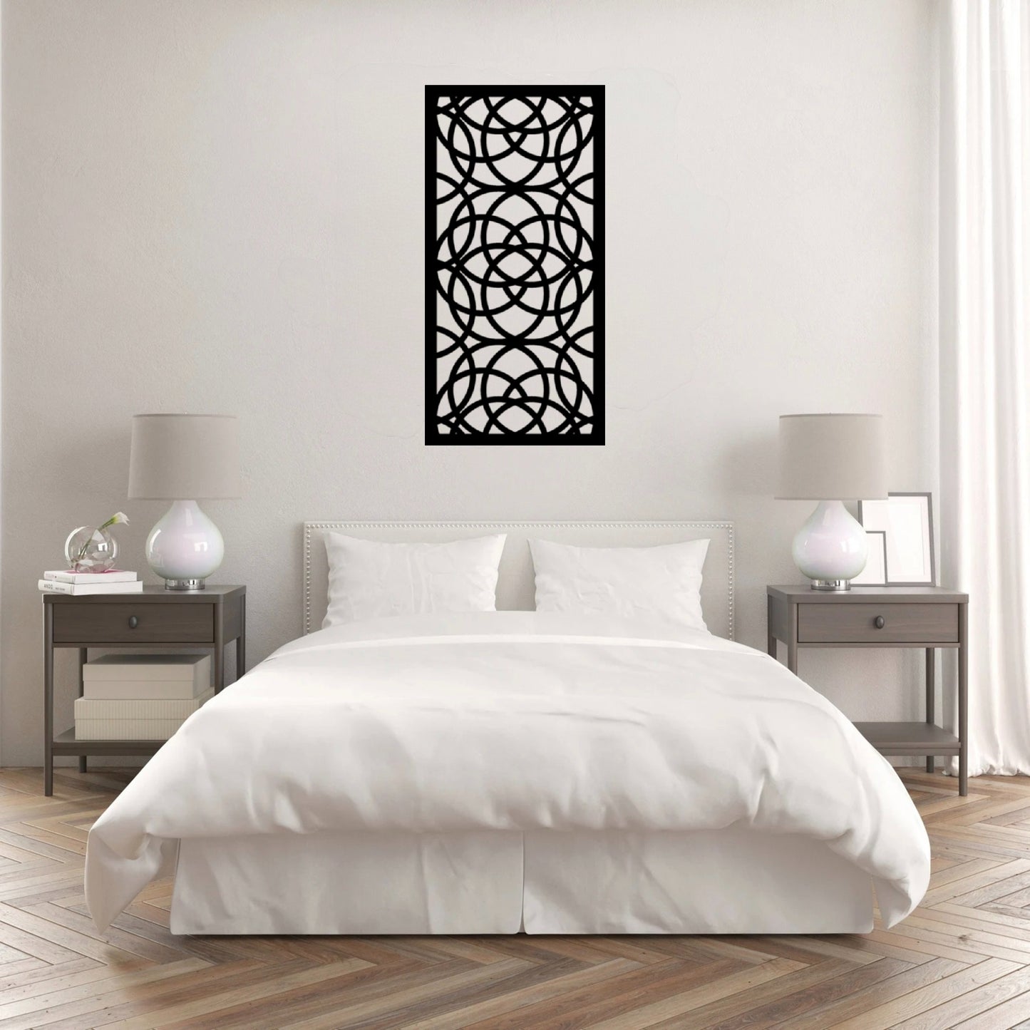 The Ellara Metal Wall Art is hung on the wall of a white bedroom, creating a sleek and contemporary focal point.