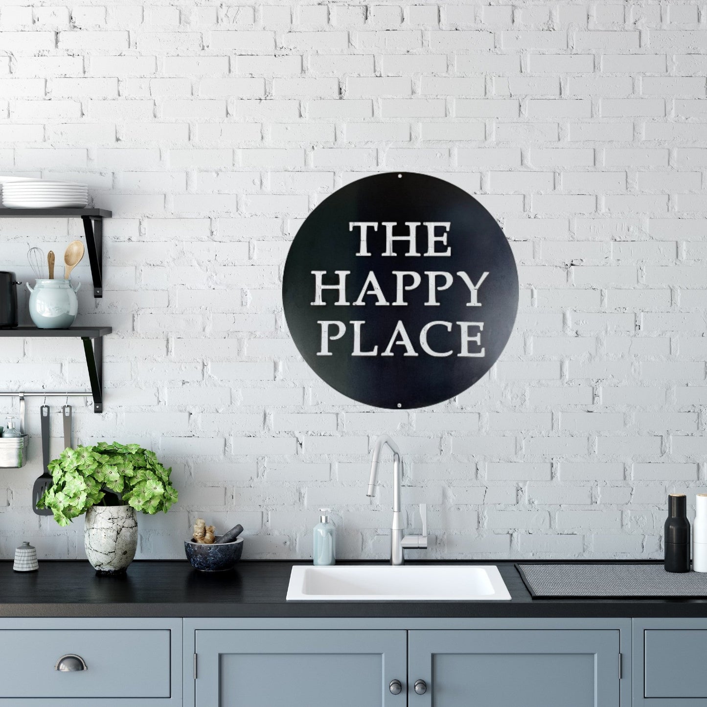 A house kitchen with brick backsplash and a custom metal sign in the shape of a circle on the wall