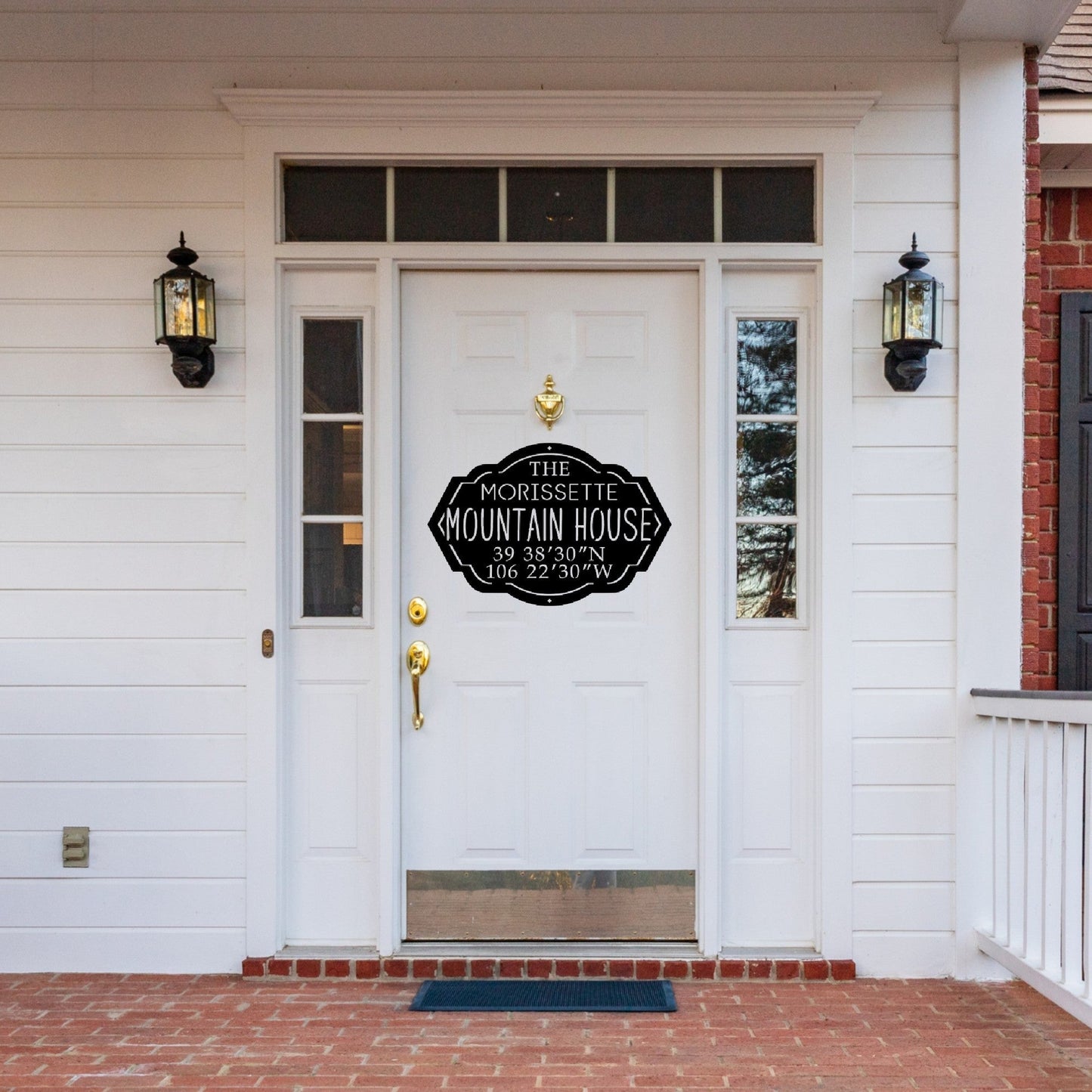 Front door of a house with a black custom metal mountain house sign
