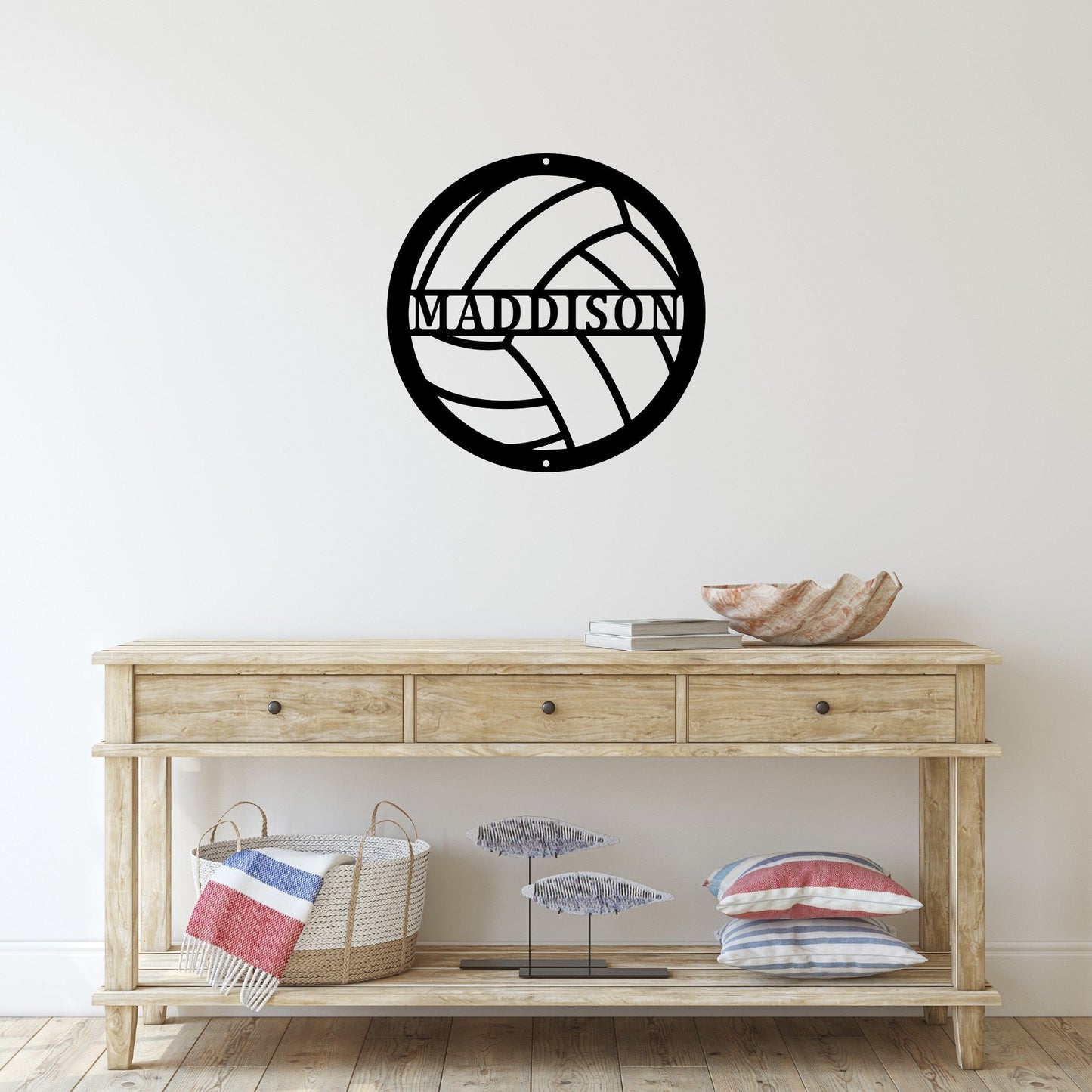 Entryway with a custom metal sign on the wall that is cut to look like a volleyball with a name in the middle