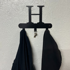 High-quality monogram hook on wall with coat and keys