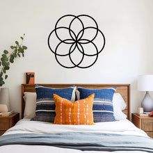 Load image into Gallery viewer, The Cerelia Metal Circles Wall Decor is tastefully hung above the bed, creating an eye-catching centerpiece on the wall. The interconnected metal circles, add a touch of modern elegance to the room.