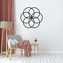 Load image into Gallery viewer, In the studio type room, the Cerelia Metal Circles Wall Decor is hung prominently on the wall, acting as a striking focal point. The circles’ smooth, adding a touch of sophistication and depth to the space.