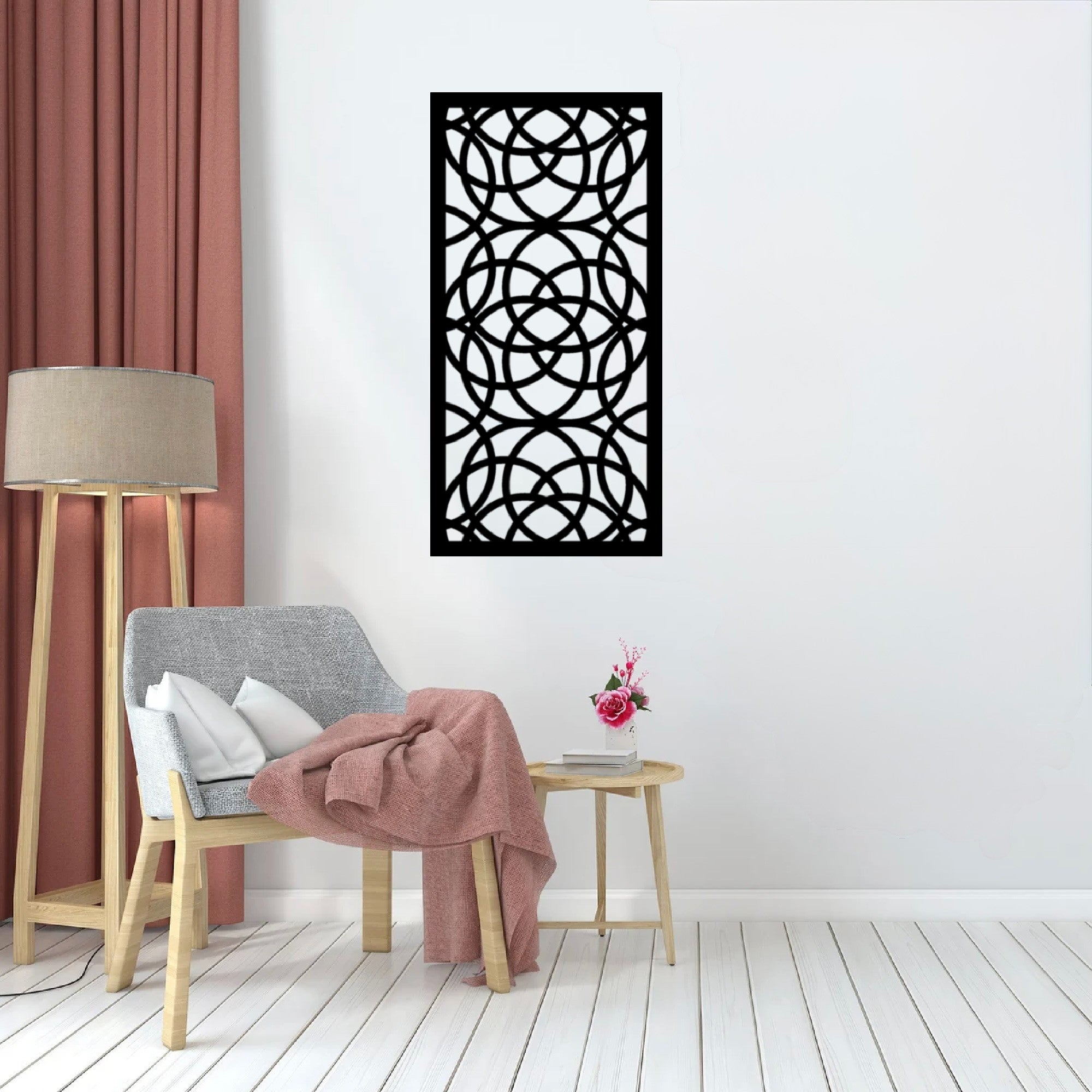 The Ellara Metal Wall Art is hung on a wall above or near a chair, creating a harmonious and visually engaging composition.