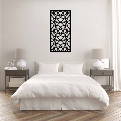 The Ellara Metal Wall Art is hung on the wall of a white bedroom, creating a sleek and contemporary focal point.