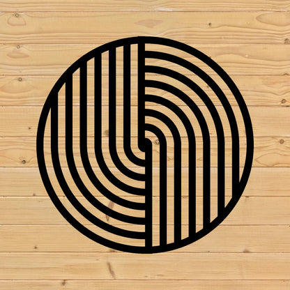The image showcases a round metal wall art piece with a bold black geometric pattern, mounted on a light wooden fence background. The clean lines of the artwork contrast with the natural wood grain and knots, creating a harmonious blend of modern and rustic aesthetics.