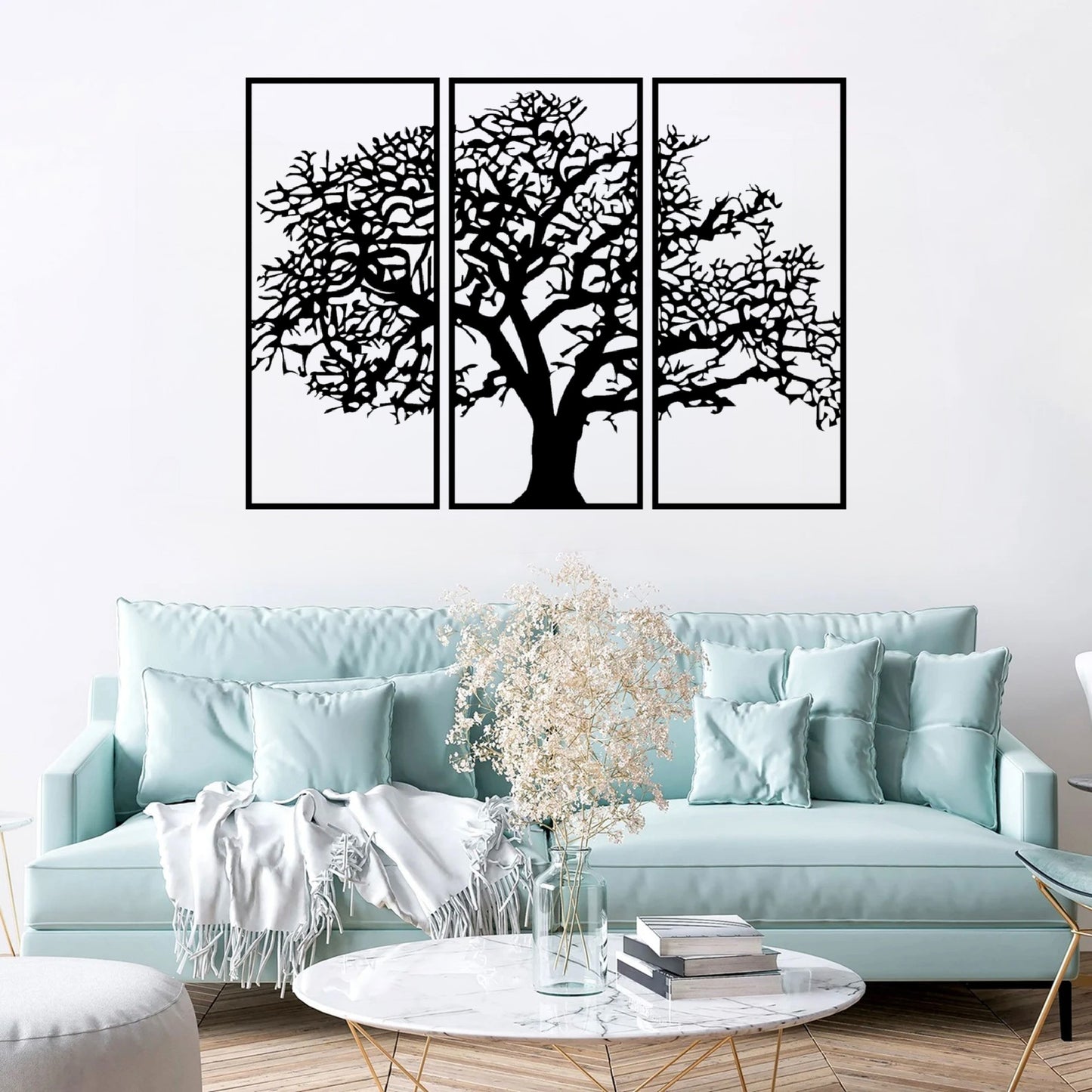 The Canopy Tree of Life Wall Art hangs gracefully on the wall above or near a light blue sofa, creating a visually soothing and elegant scene.