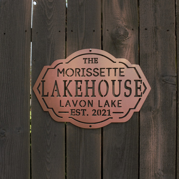 Custom family lakehouse sign hanging on wall outside of house with bronze powder coat