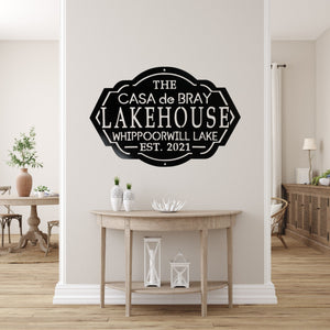 Home entryway with a custom lake house sign on the wall above a table