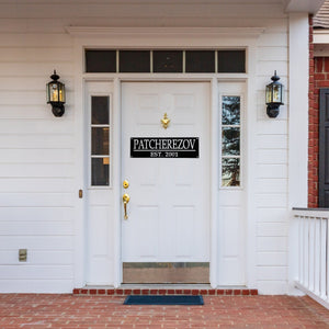 Front door of a house with a custom name sign on the door