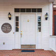 Load image into Gallery viewer, Front door of a white house with an aged copper painted custom metal sign on the wall next to the door 