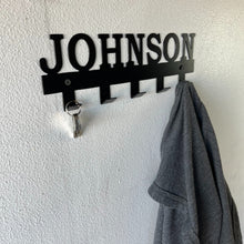 Load image into Gallery viewer, custom name coat rack on a wall with keys and a coat hanging off of it