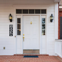 Load image into Gallery viewer, Front door of a house with a custom home house numbers sign on the left of the door hanging vertically