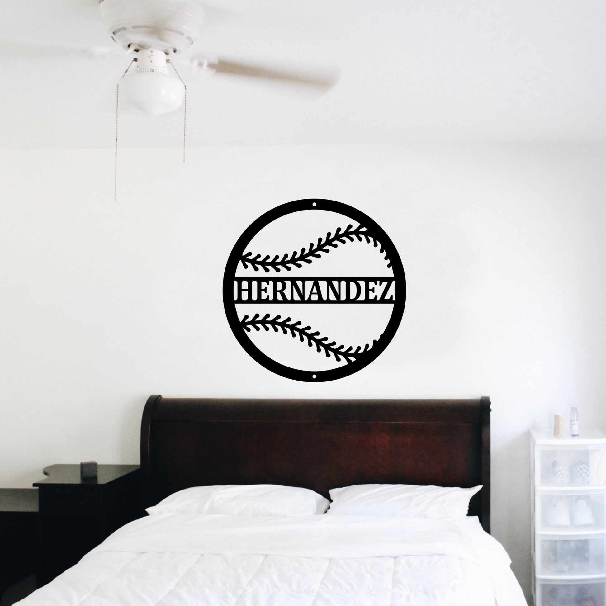 Bedroom with a large custom metal sign of a baseball above the bed