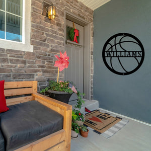 Front porch of a house with a custom basketball sign on the wall next to the door