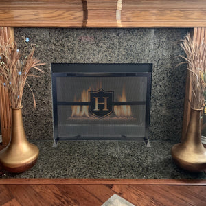 Fireplace Screen in front of a fire with custom letter and handles