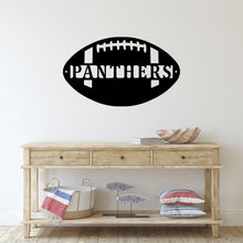 Load image into Gallery viewer, Home entryway with a table and on the wall a custom metal sign in the shape of a football