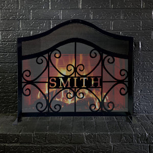 Customized fireplace screen with black brick background and fire behind it with a handle on top of the screen