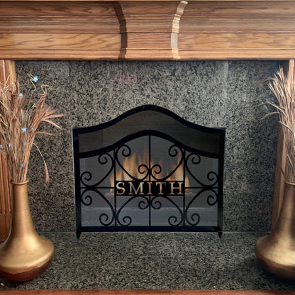 Custom arched fireplace screen in home in front of a fireplace