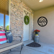 Load image into Gallery viewer, Front porch of a house with a custom metal sign in the shape of a volleyball on the wall