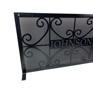 Close up of a customized personalized fireplace screen with handles and scroll and custom name design